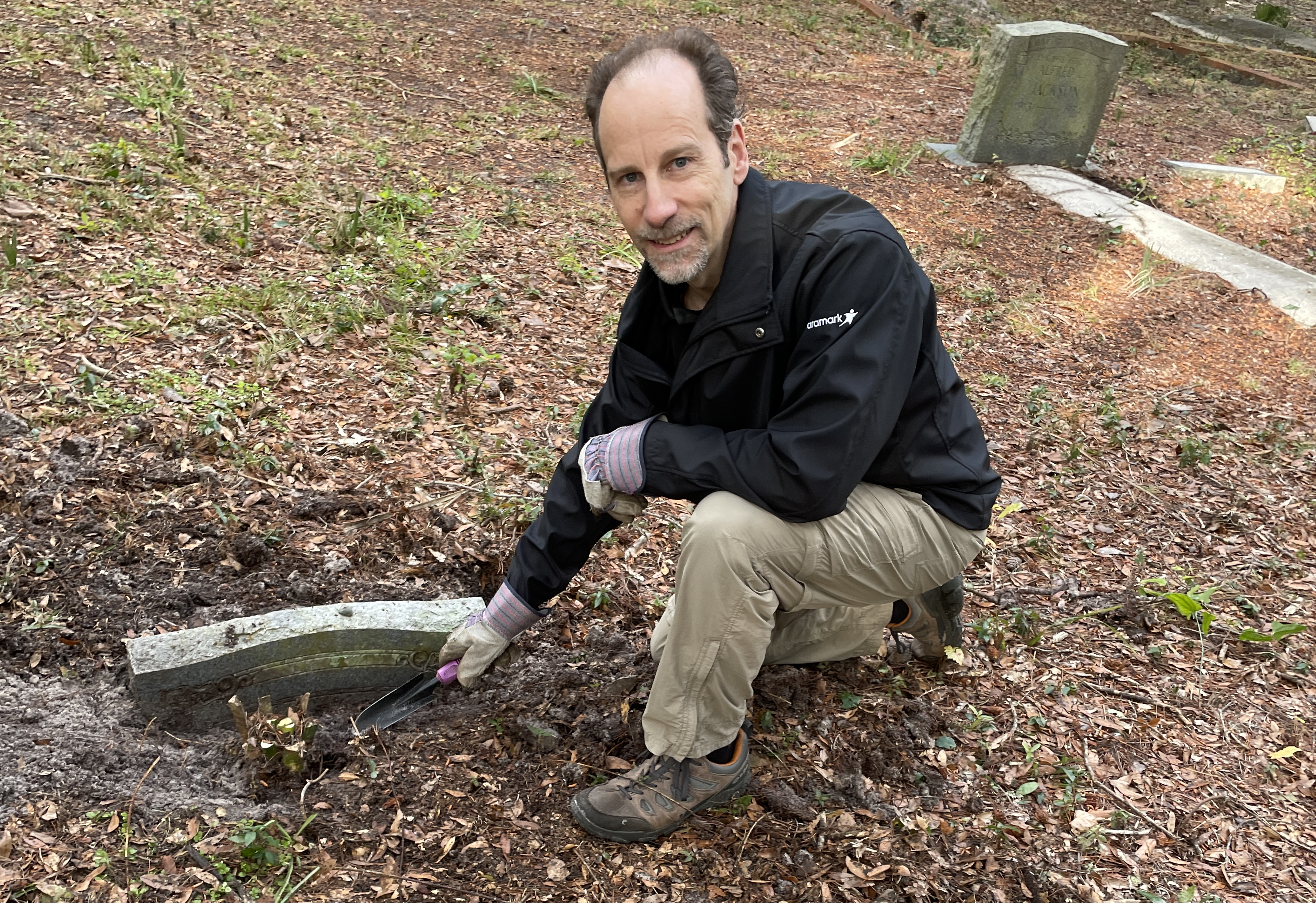 person cleaning up a cemetery